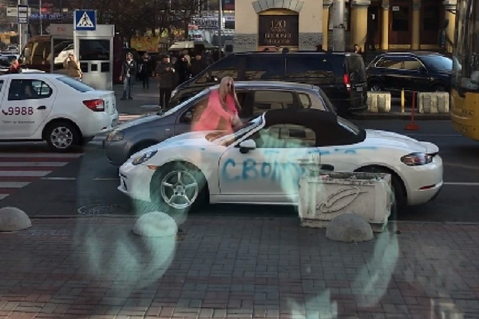 В центре Киева блондинка в розовом пальто изрубила топором Porsche