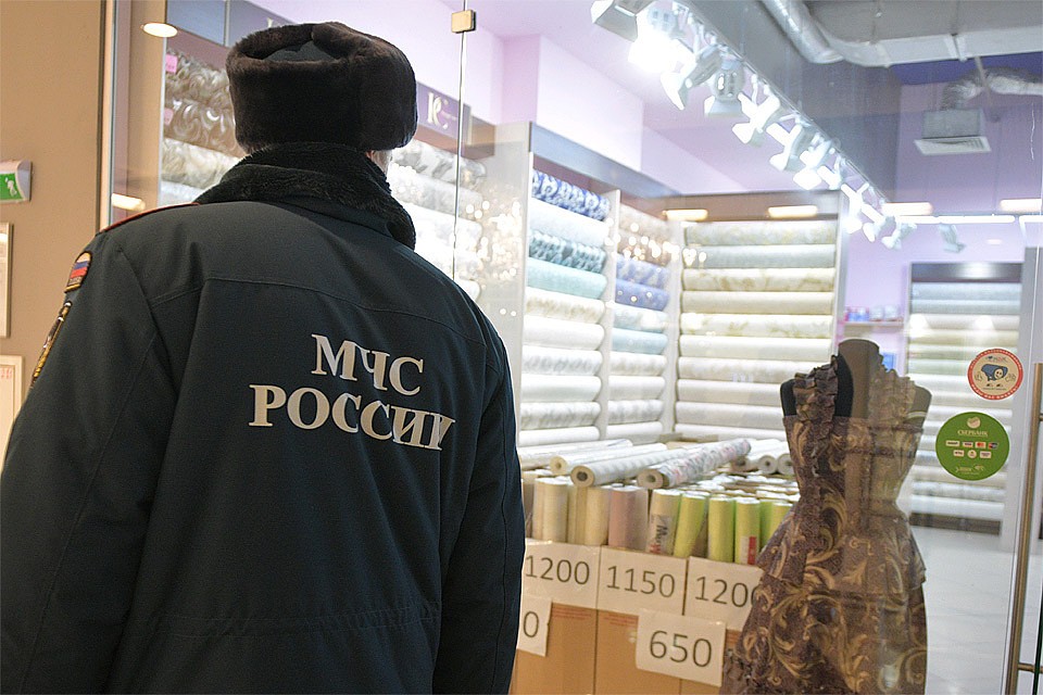 Сотрудник МЧС во время проверки пожарной безопасности в ТРЦ.